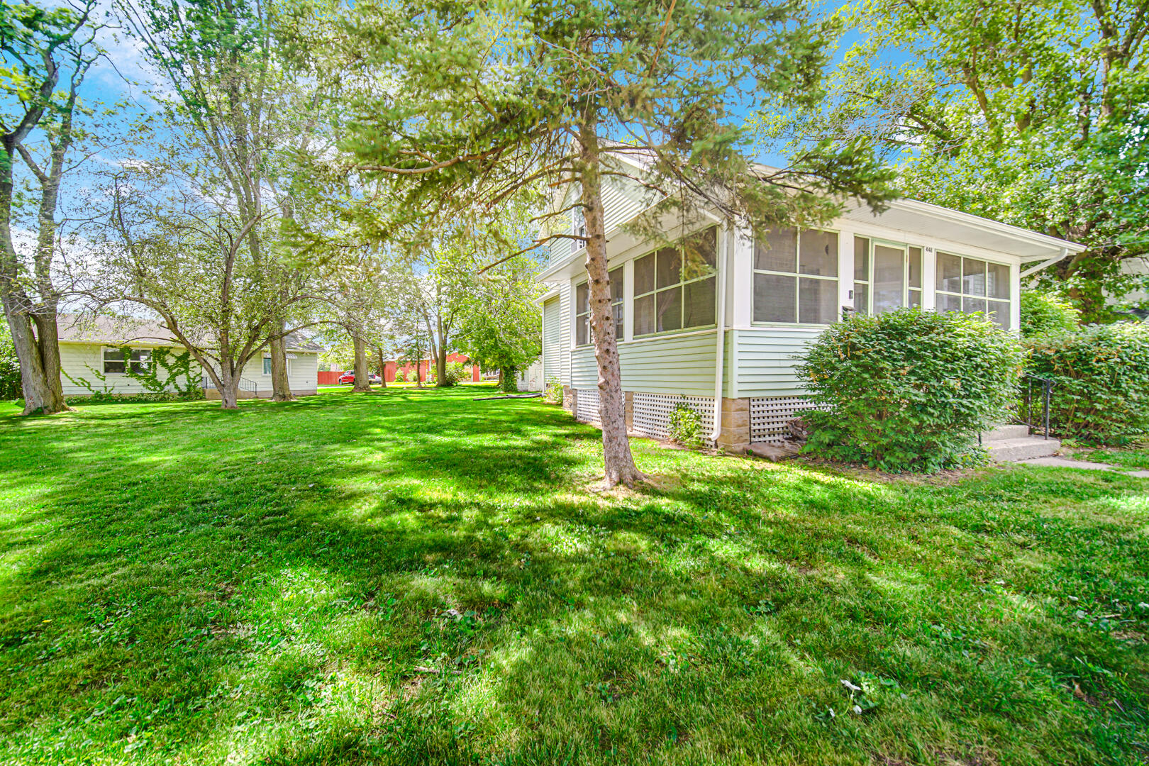 a front view of house with yard and green space