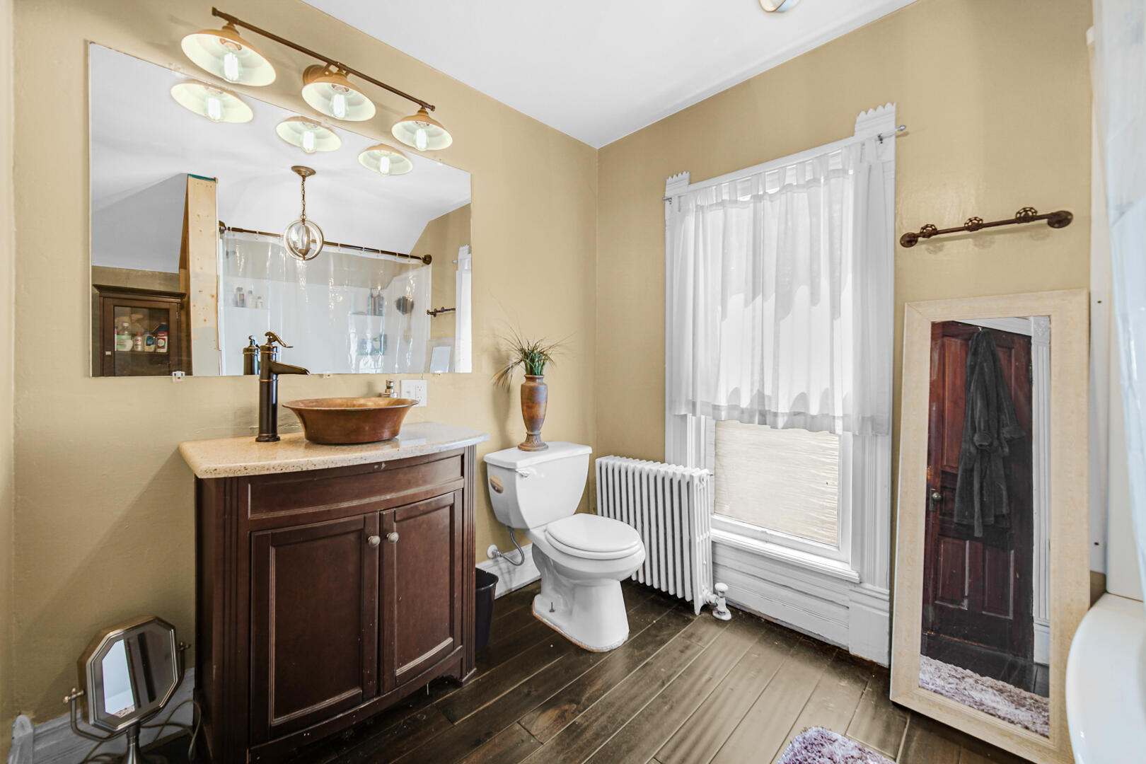 448 North Weston Street Rensselaer, IN 47978 - Photo 17 of 28 a bathroom with a toilet sink and mirror