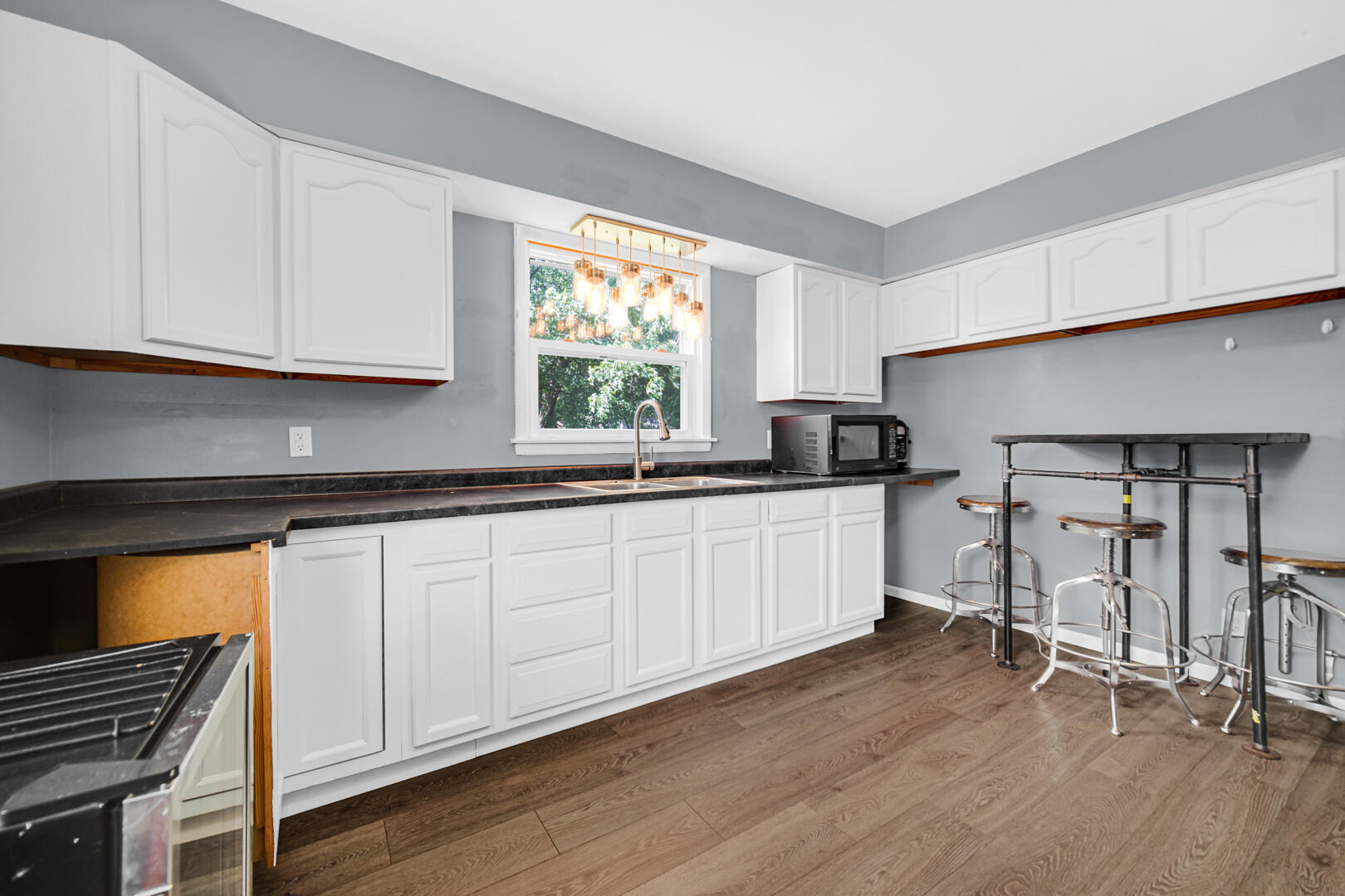 448 North Weston Street Rensselaer, IN 47978 - Photo 22 of 28 a kitchen with a sink a window and cabinets