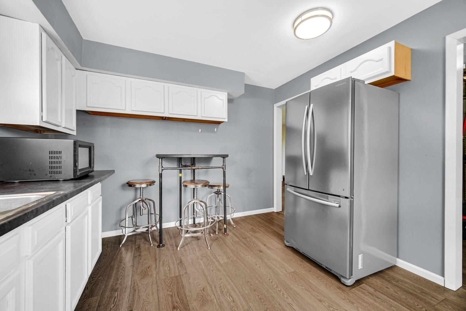 448 North Weston Street Rensselaer, IN 47978 - Photo 23 of 28 a kitchen with stainless steel appliances granite countertop a refrigerator a sink and white cabinets