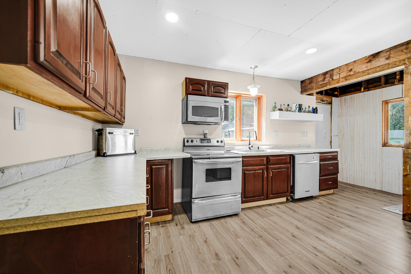 448 North Weston Street Rensselaer, IN 47978 - Photo 5 of 28 a kitchen with stainless steel appliances granite countertop a stove and a sink