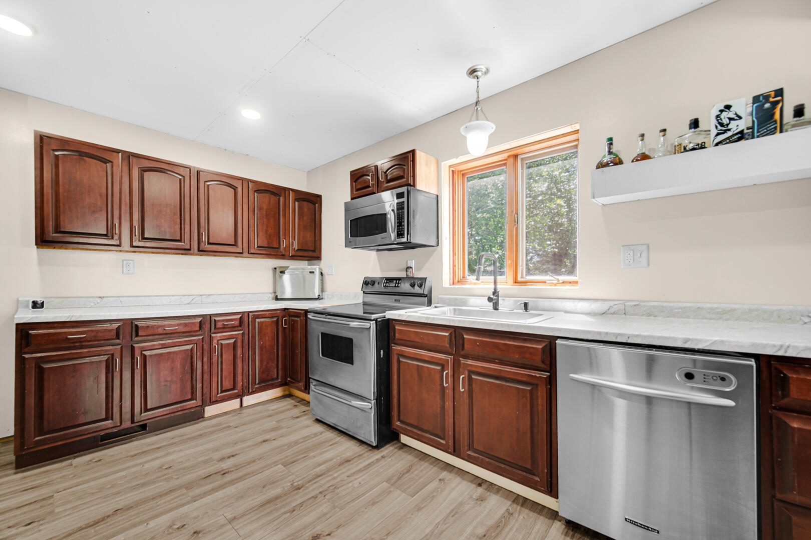 448 North Weston Street Rensselaer, IN 47978 - Photo 6 of 28 a kitchen with stainless steel appliances granite countertop wooden cabinets and sink