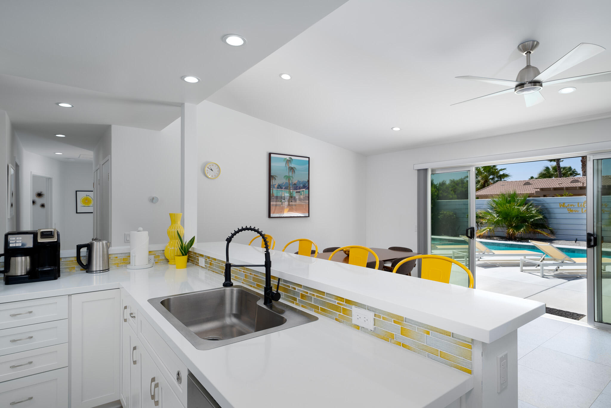 2383 East Powell Road Palm Springs, CA 92262 - Photo 12 of 32 a kitchen with a sink and a refrigerator