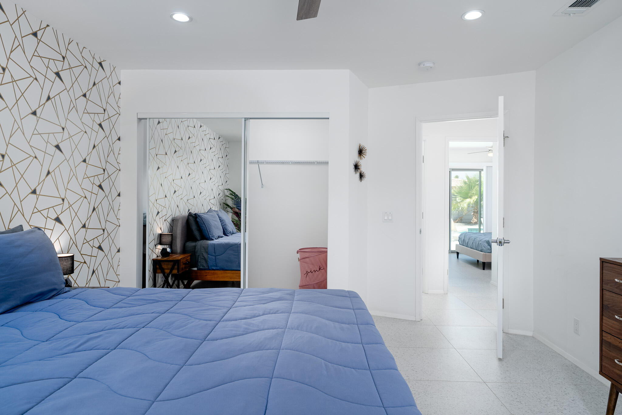 2383 East Powell Road Palm Springs, CA 92262 - Photo 18 of 32 a bedroom with a large bed and a chandelier