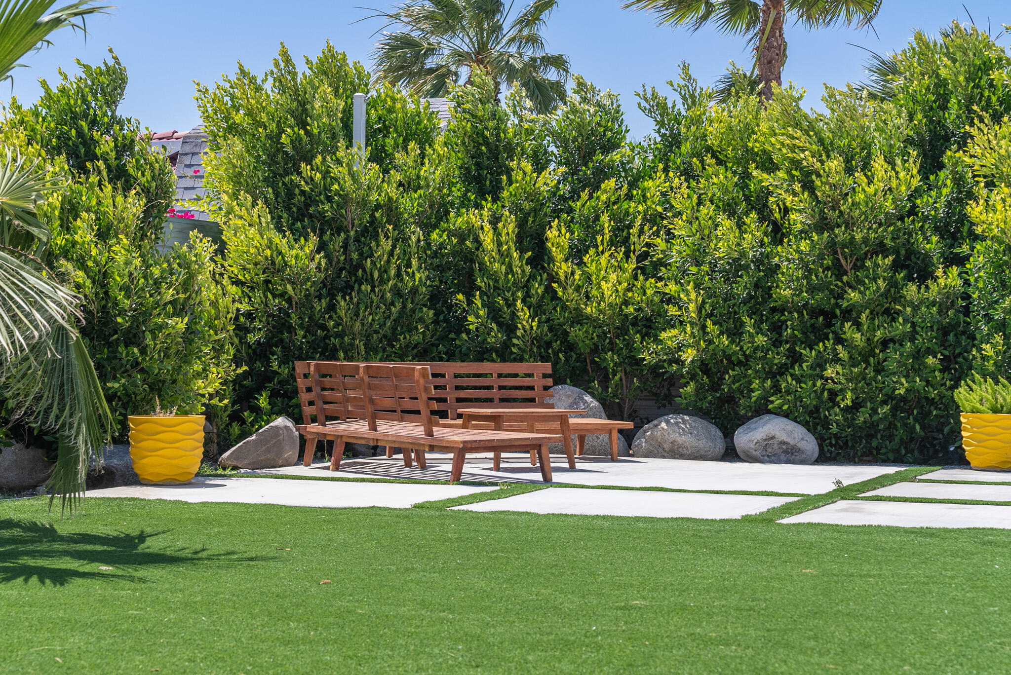 2383 East Powell Road Palm Springs, CA 92262 - Photo 32 of 32 a view of a fountain with a bench in a garden