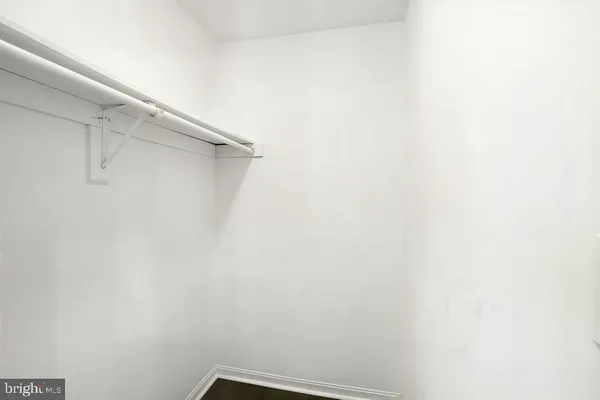 a bathroom with a sink a toilet a mirror and shower