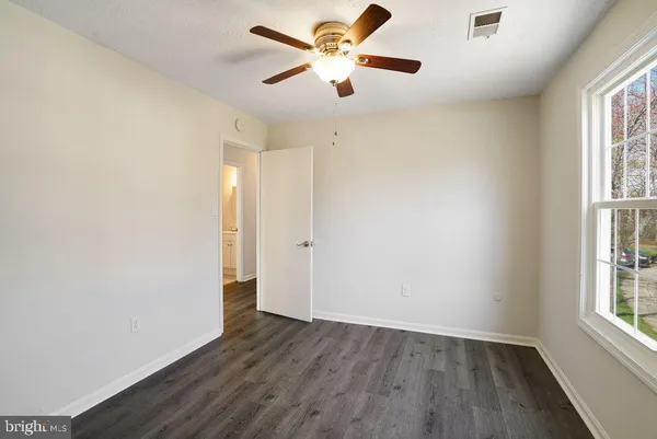a kitchen with granite countertop a refrigerator and a sink