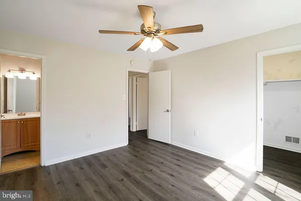 a kitchen with granite countertop a refrigerator and a stove top oven