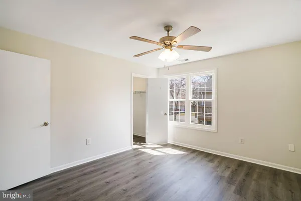 a view of a big house with a yard and large tree