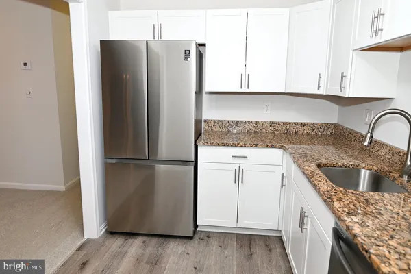 a kitchen with a refrigerator sink and stove
