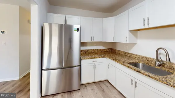 a kitchen with stainless steel appliances granite countertop a refrigerator sink and cabinets