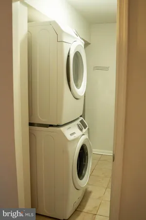 a view of a room with wooden floor and white walls