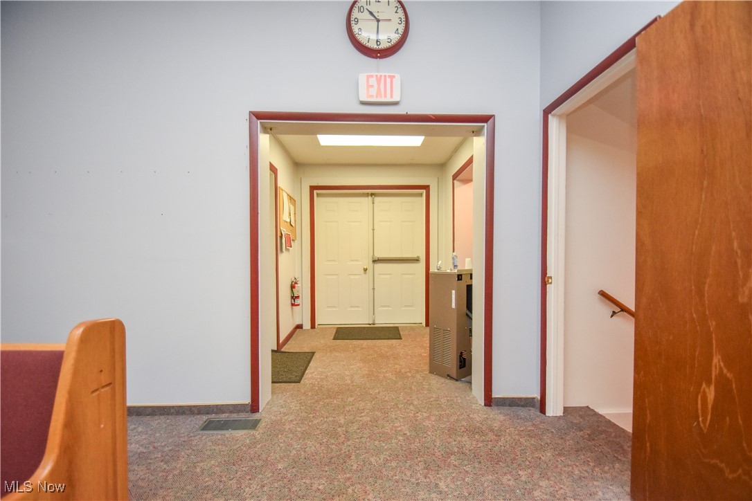 1187 Deforest Road Southeast Warren, OH 44484 - Photo 23 of 42 Hallway featuring carpet flooring, an upstairs landing, and baseboards