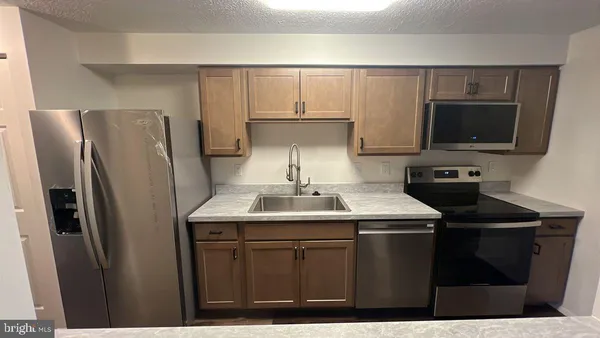 a kitchen with a sink and refrigerator