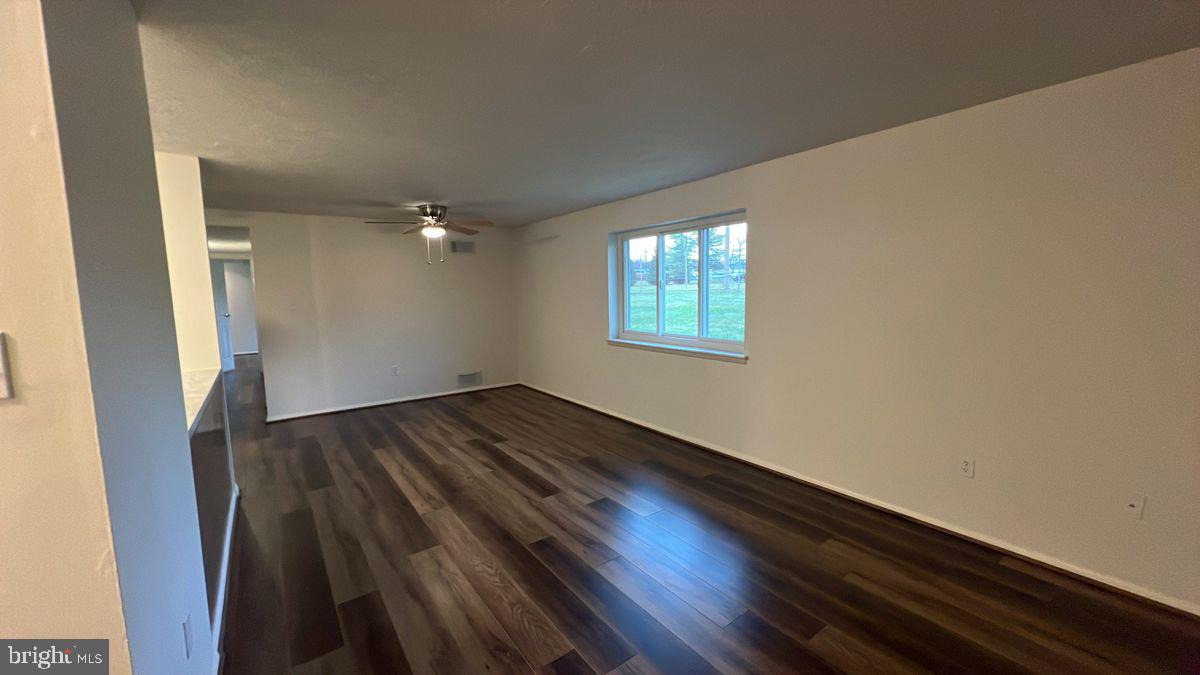 730 B Heather Ridge Drive, Unit 14B Frederick, MD 21702 - Photo 5 of 13 an empty room with wooden floor and windows