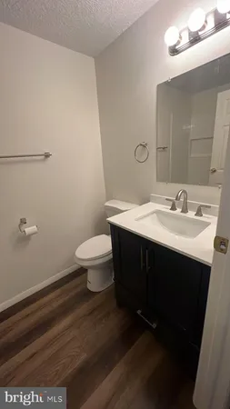 a bathroom with a sink a toilet and mirror