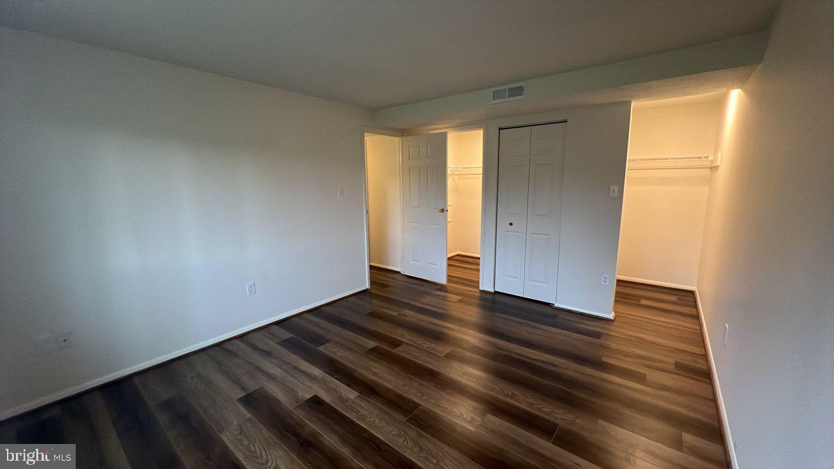 730 B Heather Ridge Drive, Unit 14B Frederick, MD 21702 - Photo 9 of 13 a view of an empty room with wooden floor and a window