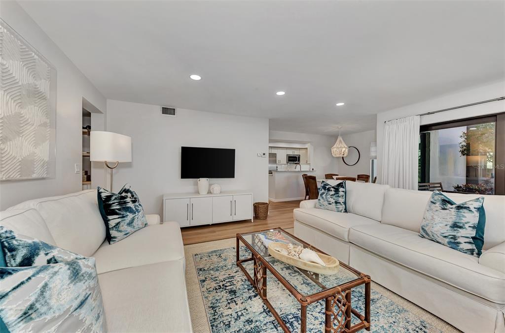 2950 North Beach Road, Unit A315 Englewood, FL 34223 - Photo 11 of 64 a living room with furniture and a flat screen tv