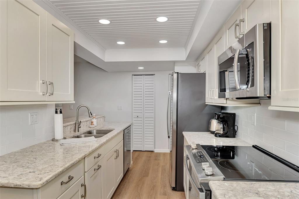 2950 North Beach Road, Unit A315 Englewood, FL 34223 - Photo 20 of 64 a kitchen with a sink stove and cabinets