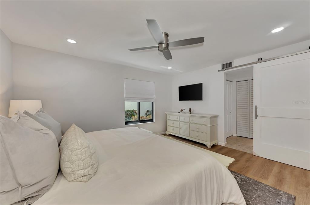 2950 North Beach Road, Unit A315 Englewood, FL 34223 - Photo 23 of 64 a bedroom with a bed tv and a window