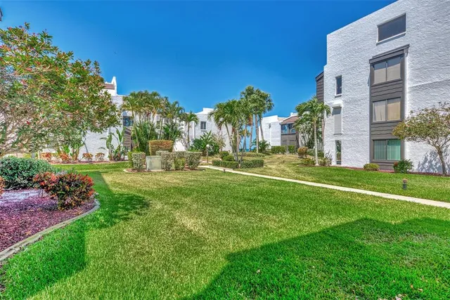 a view of a patio with a table and chairs and potted plants