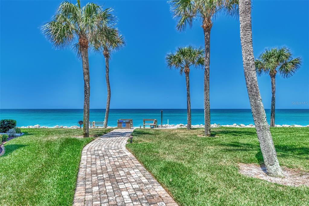 2950 North Beach Road, Unit A315 Englewood, FL 34223 - Photo 36 of 64 a front view of a garden with a palm tree