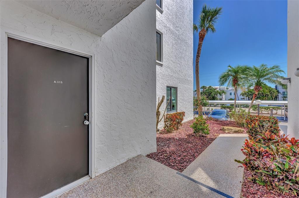 2950 North Beach Road, Unit A315 Englewood, FL 34223 - Photo 4 of 64 a view of a house with a flower garden