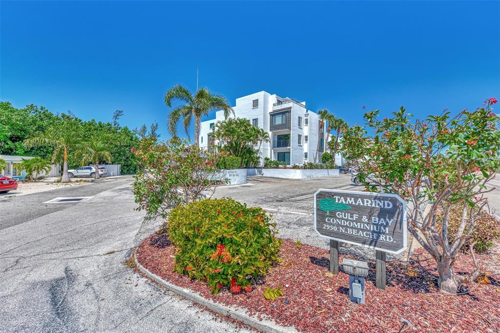 2950 North Beach Road, Unit A315 Englewood, FL 34223 - Photo 41 of 64 a front view of a house with a yard