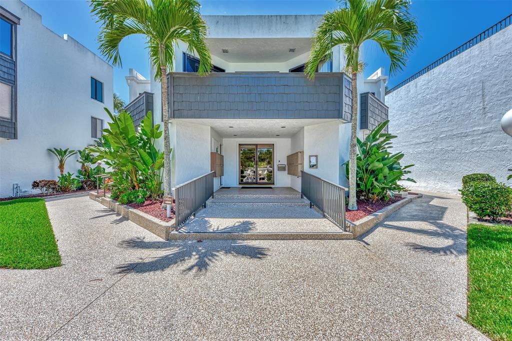 2950 North Beach Road, Unit A315 Englewood, FL 34223 - Photo 42 of 64 a house with a yard and palm trees