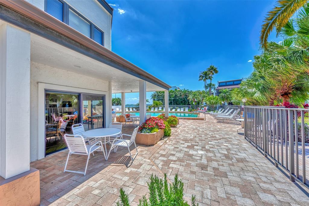 2950 North Beach Road, Unit A315 Englewood, FL 34223 - Photo 44 of 64 a view of a patio with a table and chairs and potted plants