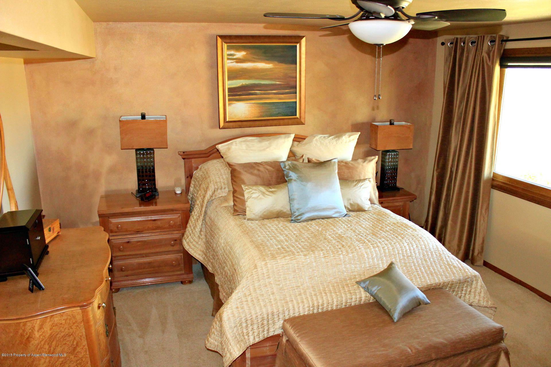 1018 County Road 294 Rifle, CO 81650 - Photo 12 of 31 a bedroom with a bed and window
