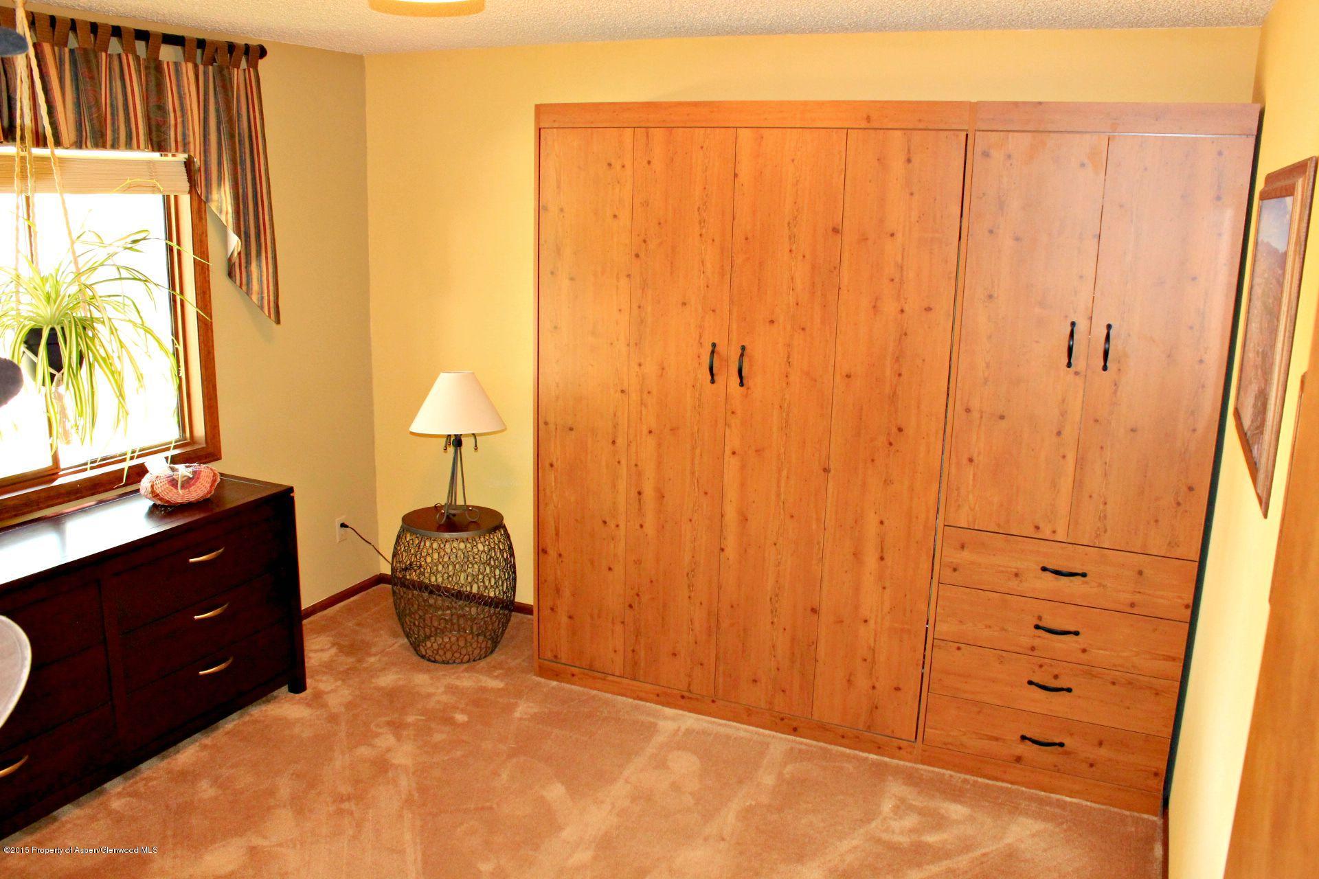 1018 County Road 294 Rifle, CO 81650 - Photo 8 of 31 a bedroom with a bed and a dresser