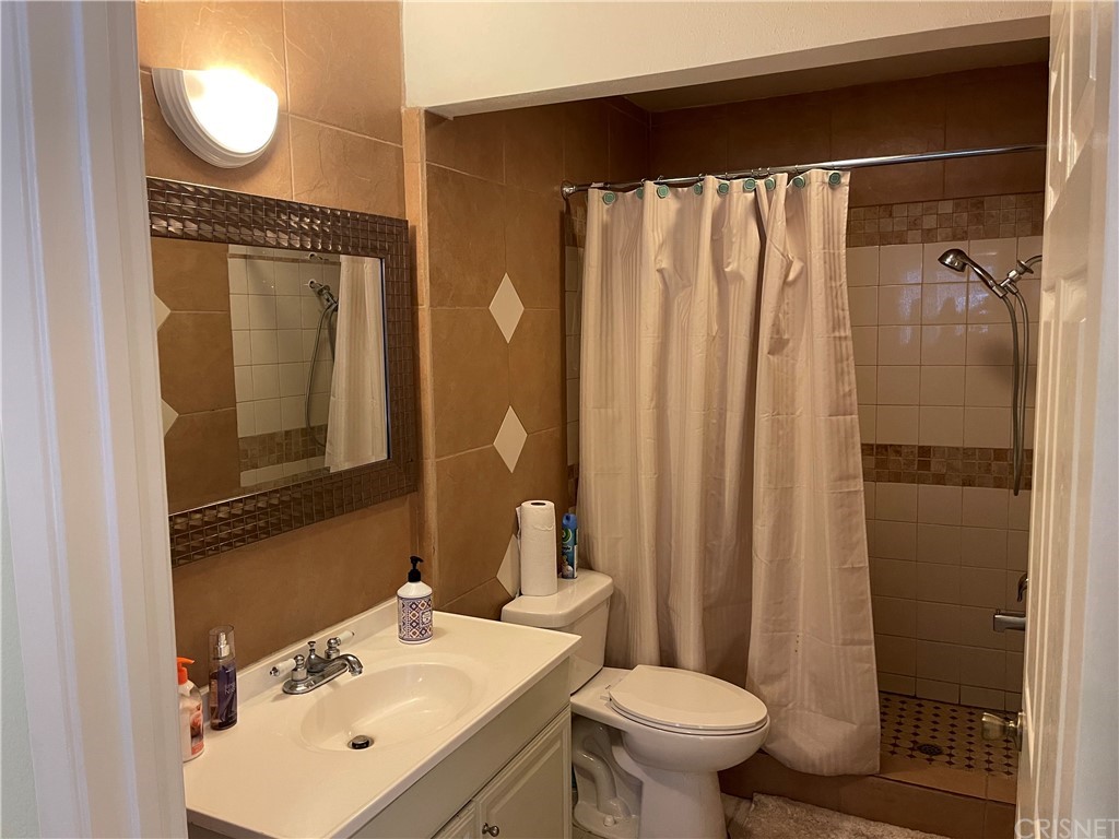 7641 Reseda Boulevard, Unit 118 Reseda, CA 91335 - Photo 11 of 16 a bathroom with a sink toilet and shower