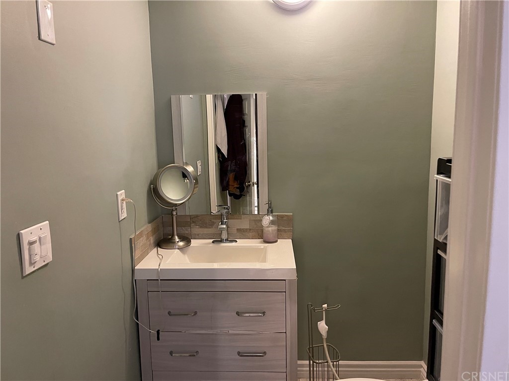 7641 Reseda Boulevard, Unit 118 Reseda, CA 91335 - Photo 3 of 16 a bathroom with a sink and a mirror