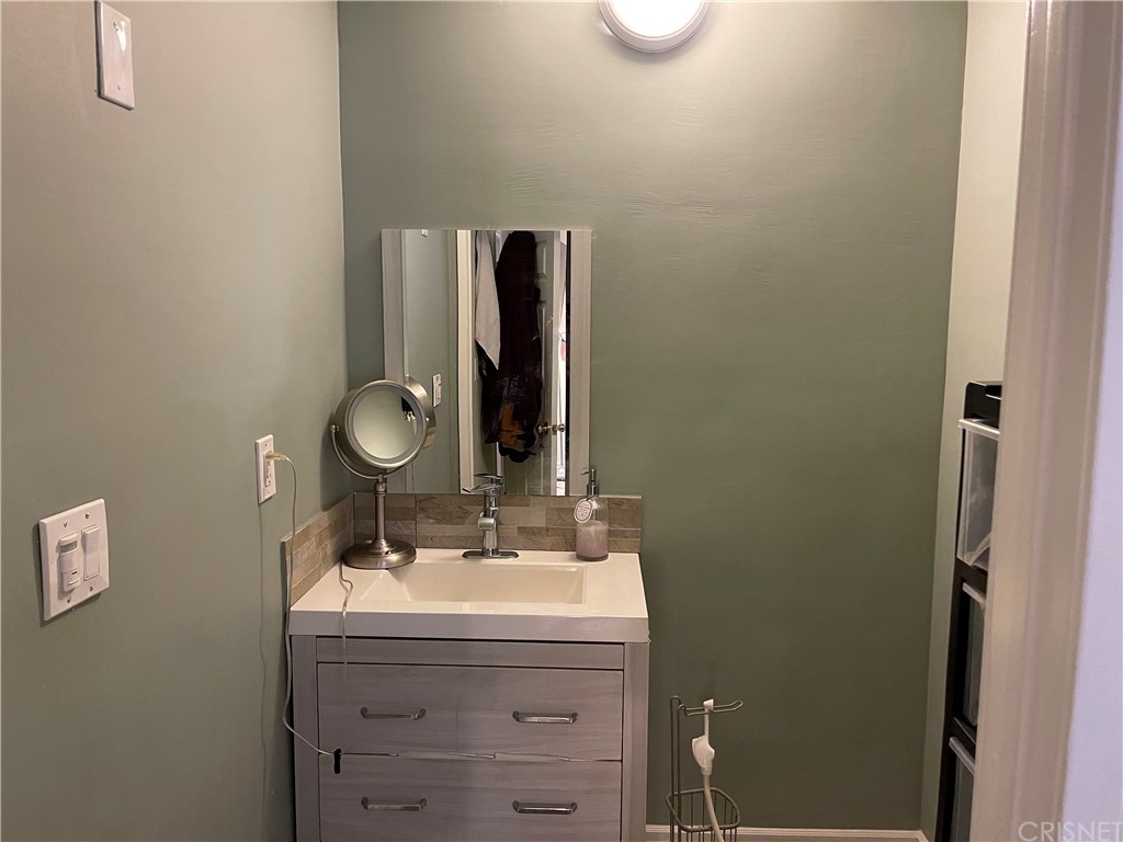 7641 Reseda Boulevard, Unit 118 Reseda, CA 91335 - Photo 9 of 16 a bathroom with a sink and a mirror
