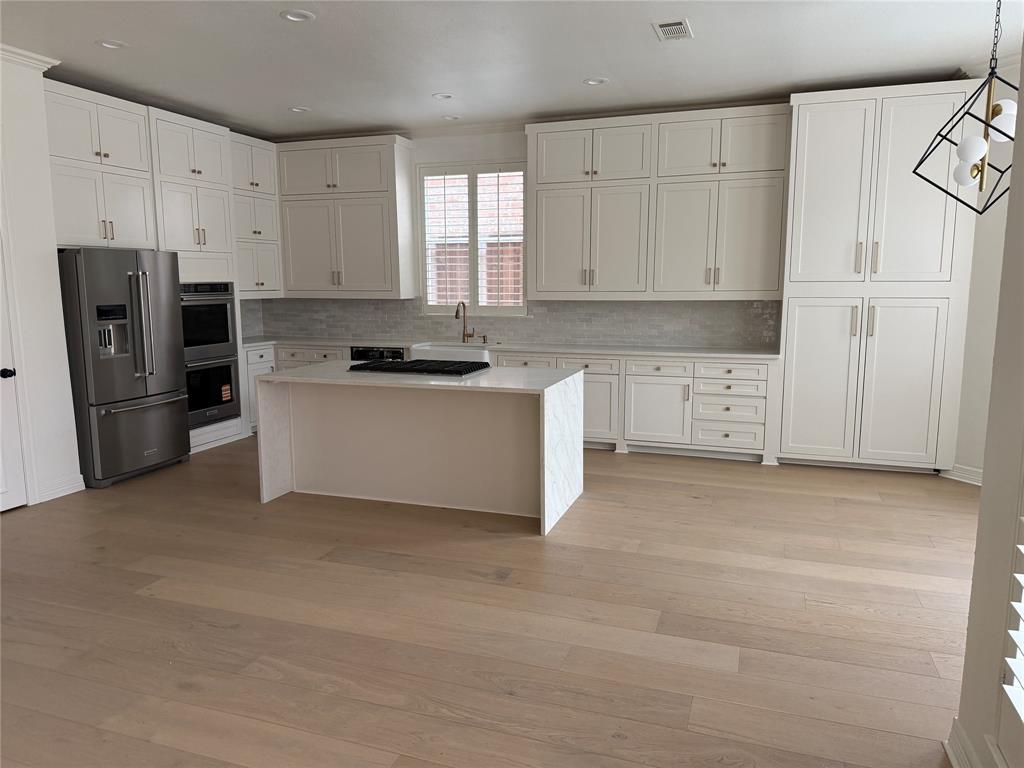 5312 Tennington Park Dallas, TX 75287 - Photo 11 of 19 a kitchen with stainless steel appliances granite countertop a refrigerator and a stove