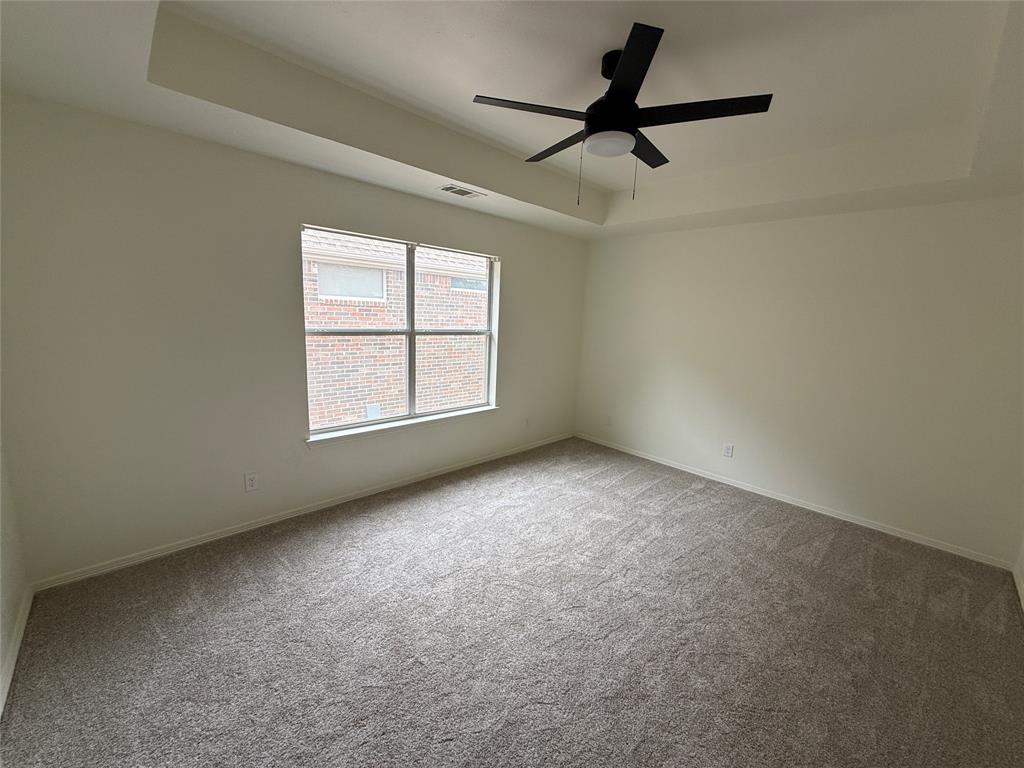 5312 Tennington Park Dallas, TX 75287 - Photo 17 of 19 an empty room with a ceiling fan and windows