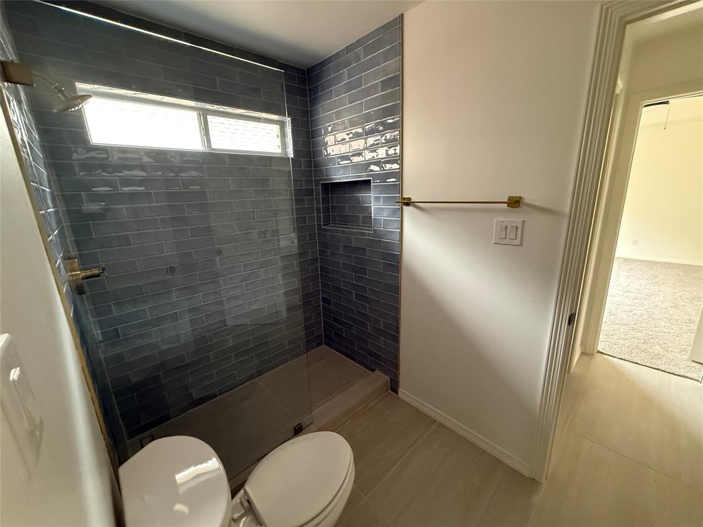 5312 Tennington Park Dallas, TX 75287 - Photo 18 of 19 a bathroom with a toilet and a shower