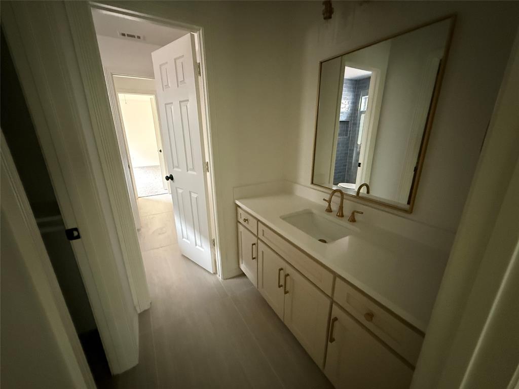5312 Tennington Park Dallas, TX 75287 - Photo 19 of 19 a bathroom with a double vanity sink and mirror