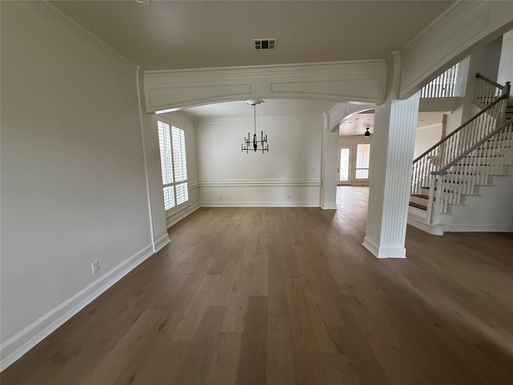 5312 Tennington Park Dallas, TX 75287 - Photo 7 of 19 a view of a hallway with wooden floor and stairs