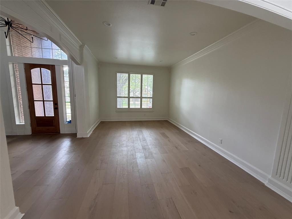 5312 Tennington Park Dallas, TX 75287 - Photo 8 of 19 an empty room with wooden floor and windows