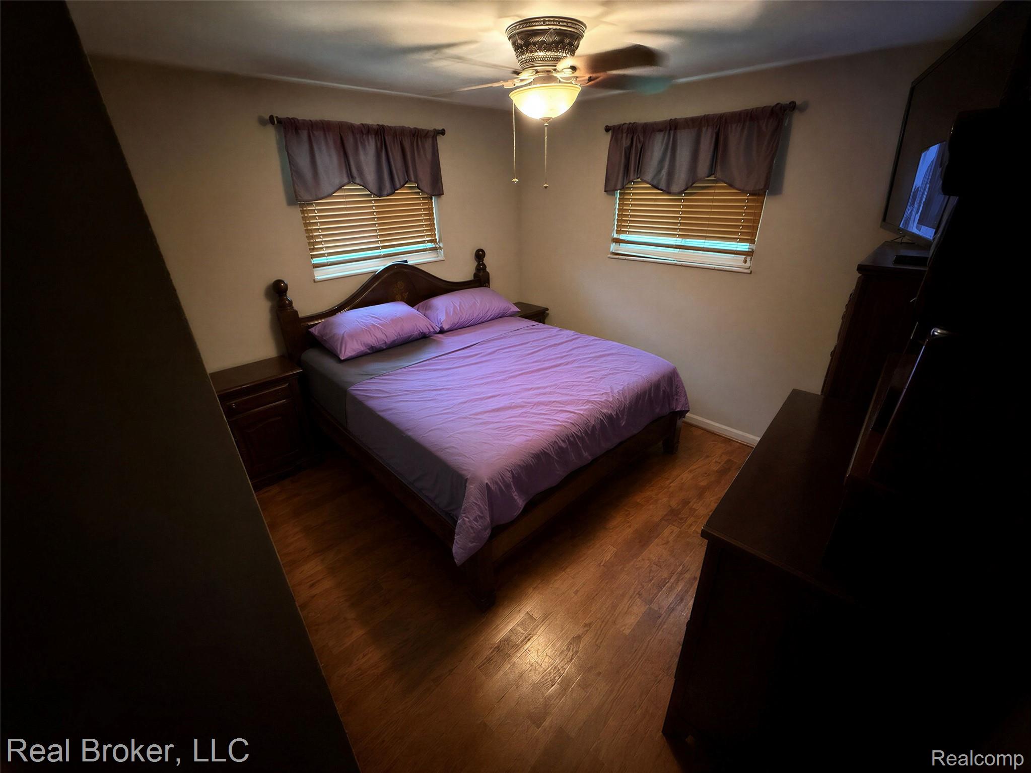 3412 South Reese Road Frankenmuth, MI 48734 - Photo 6 of 17 Bedroom featuring dark wood-style floors and a ceiling fan