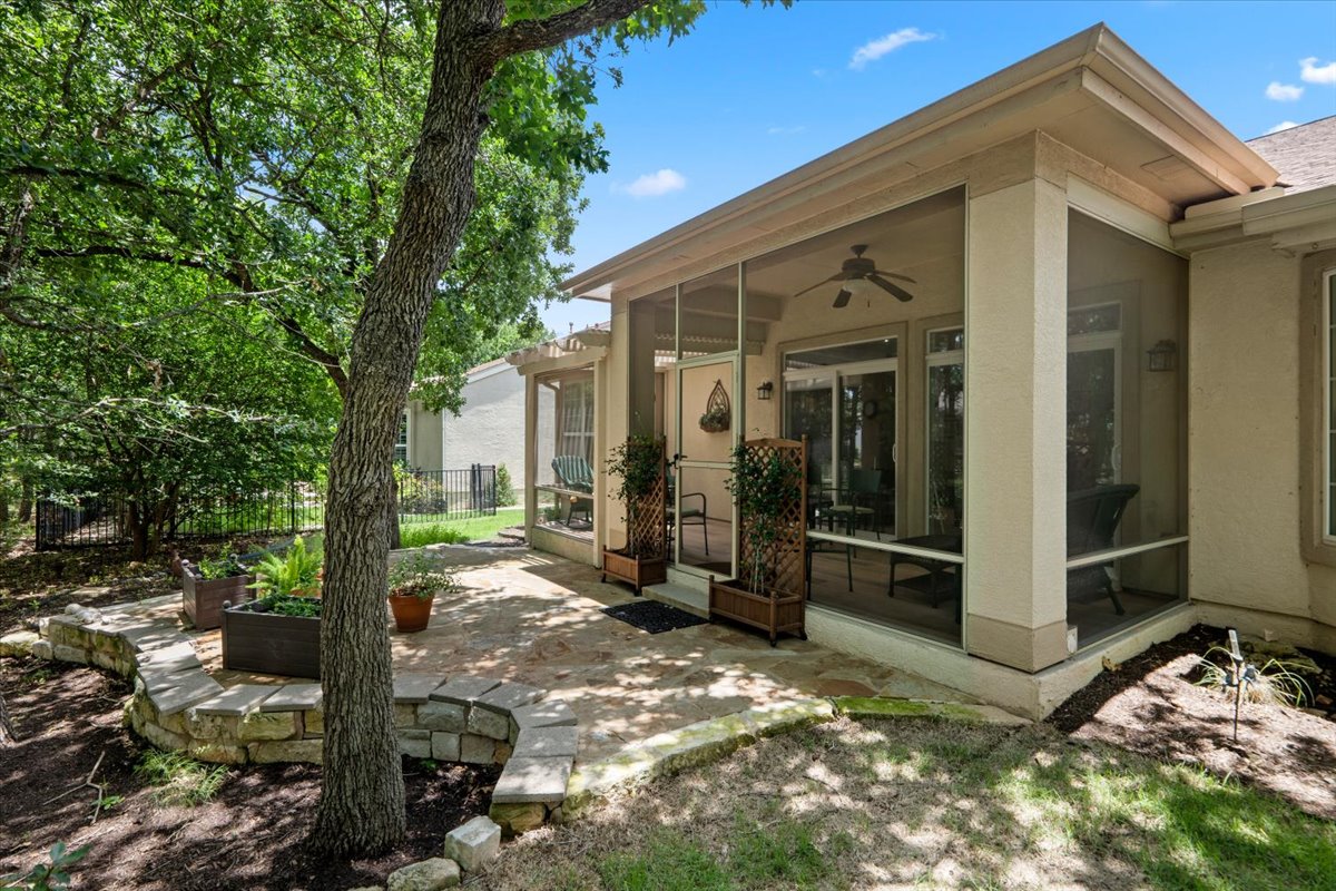 503 Breezeway Lane Georgetown, TX 78633 - Photo 35 of 38 Private-feeling outdoor space with multiple seating areas, perfect for enjoying the heavily treed green space behind the home.