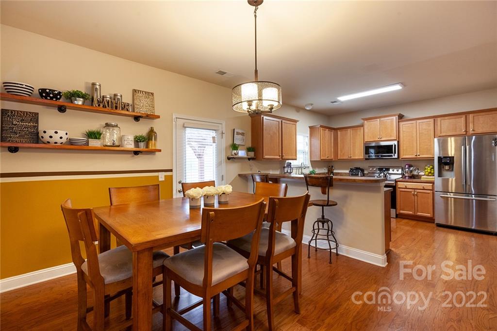 688 Winding Branch Road Rock Hill, SC 29732 - Photo 11 of 38 a dining room with stainless steel appliances kitchen island granite countertop a dining table chairs and a refrigerator