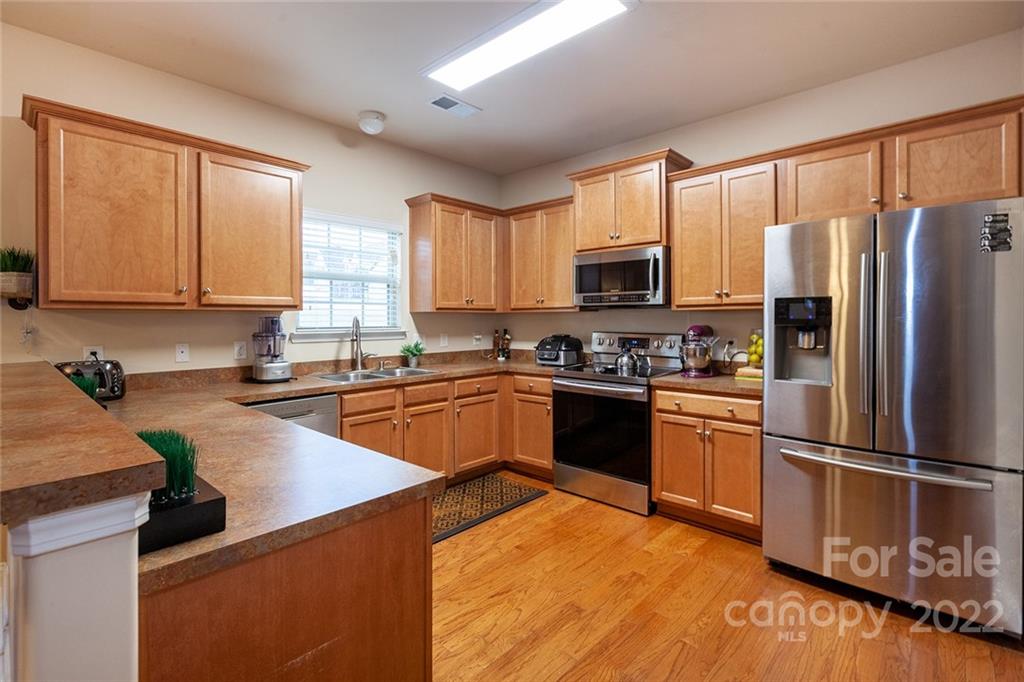 688 Winding Branch Road Rock Hill, SC 29732 - Photo 13 of 38 a kitchen with granite countertop a refrigerator stove top oven and sink