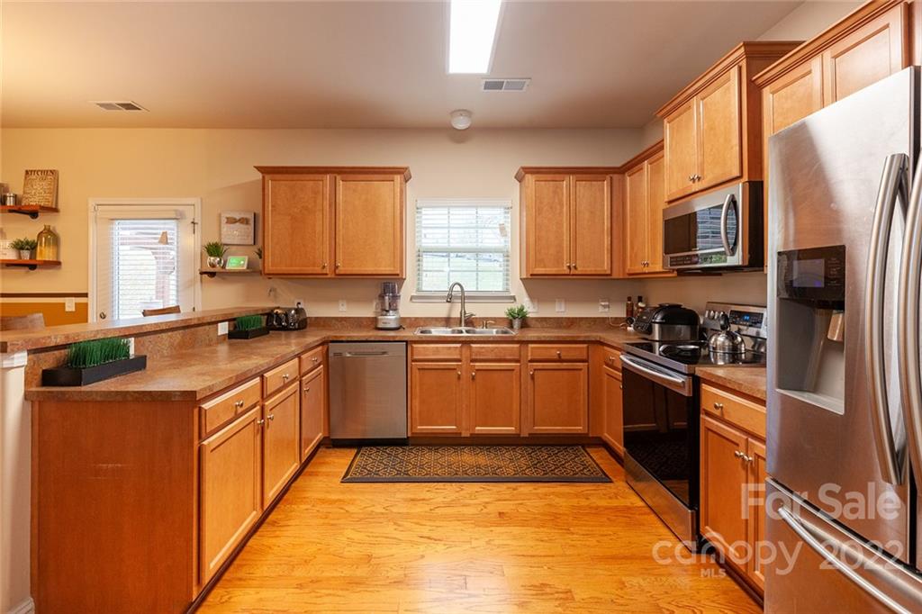 688 Winding Branch Road Rock Hill, SC 29732 - Photo 14 of 38 a large kitchen with stainless steel appliances granite countertop a stove a sink dishwasher and a refrigerator
