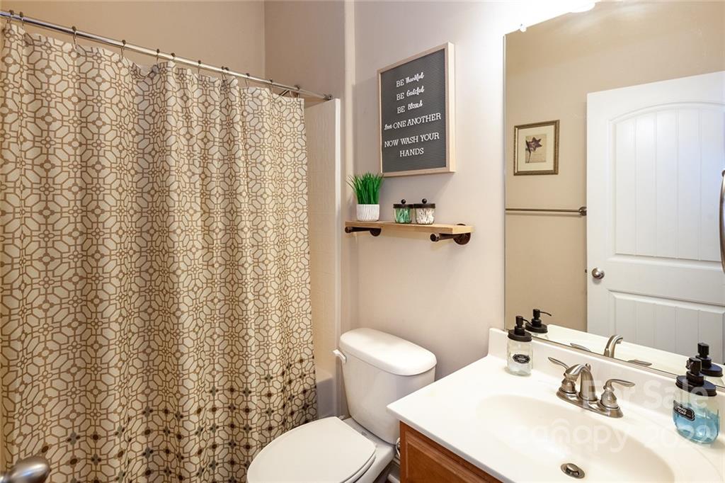 688 Winding Branch Road Rock Hill, SC 29732 - Photo 16 of 38 a bathroom with a sink a toilet and a mirror