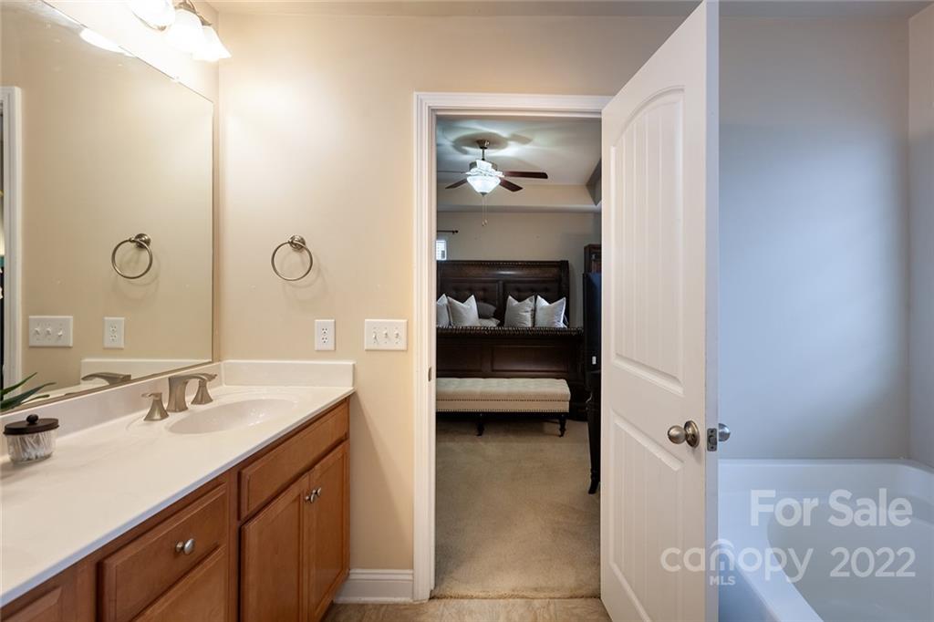 688 Winding Branch Road Rock Hill, SC 29732 - Photo 25 of 38 a en suite bathroom with a sink a mirror and a shower
