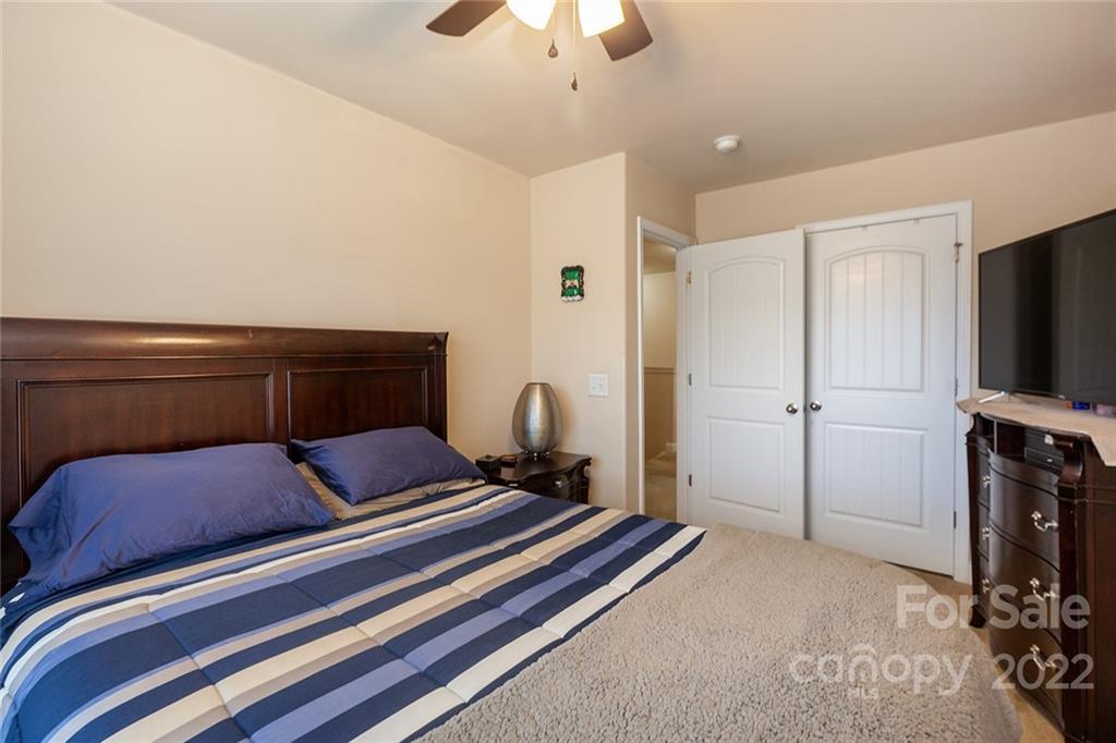 688 Winding Branch Road Rock Hill, SC 29732 - Photo 27 of 38 a bedroom with a bed and a flat screen tv