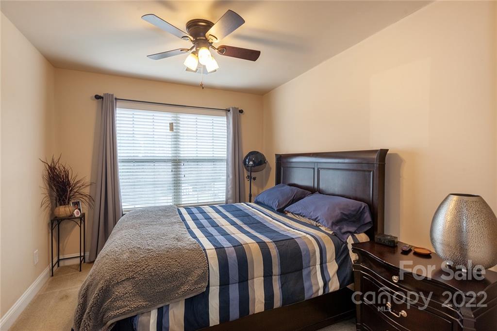688 Winding Branch Road Rock Hill, SC 29732 - Photo 28 of 38 a bedroom with a bed and a chandelier